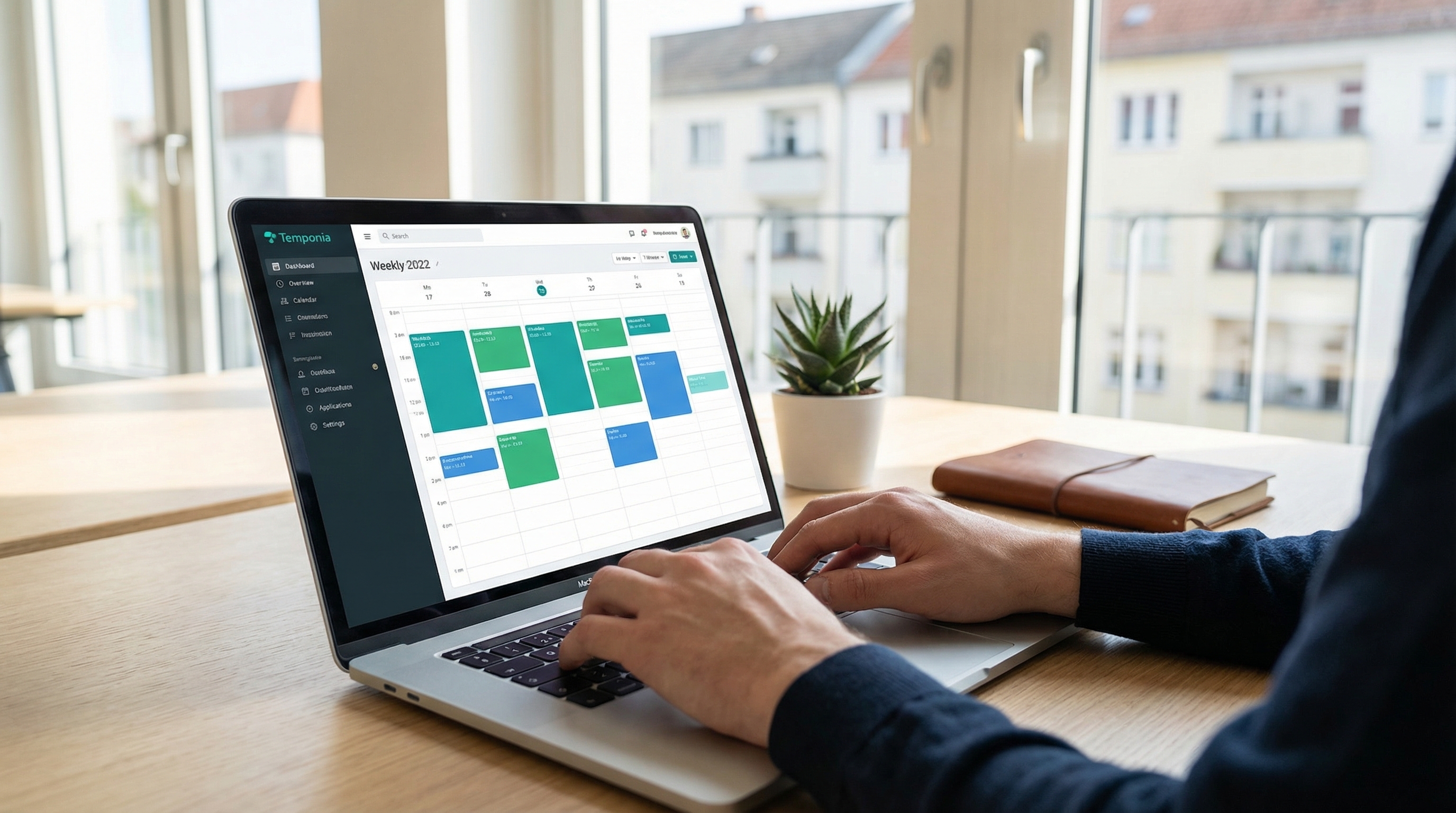 Employee using a digital time tracking application on a laptop in a bright German workspace